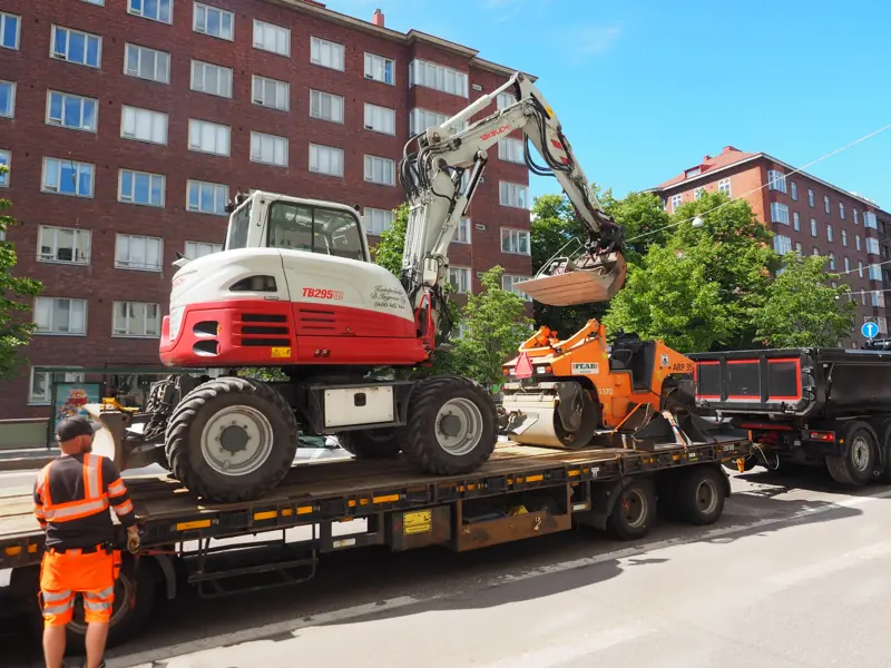 Excavator and road roller loaded on a truck