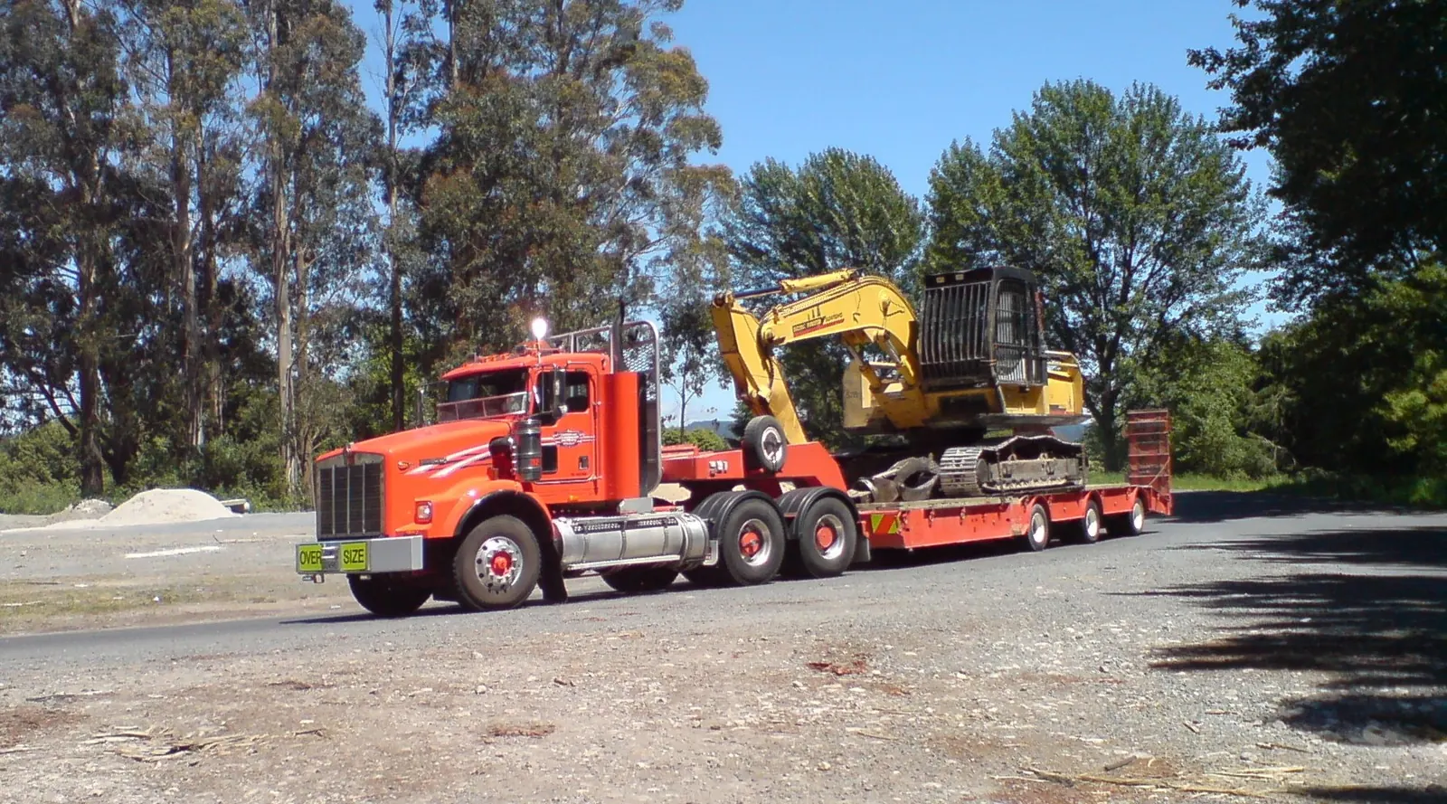 Excavator transported on a low-bed trailer