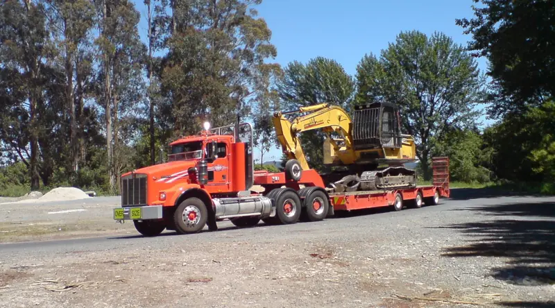 Excavator transported on a low-bed trailer