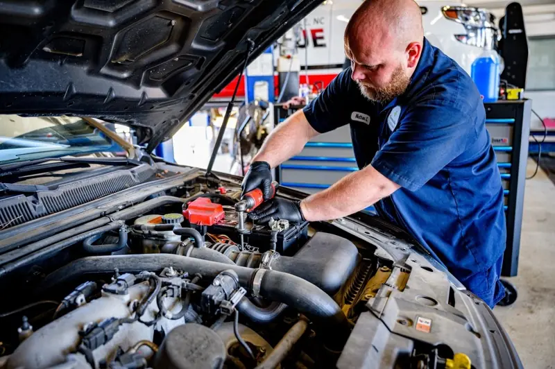 Mechanic working on a vehicle engine