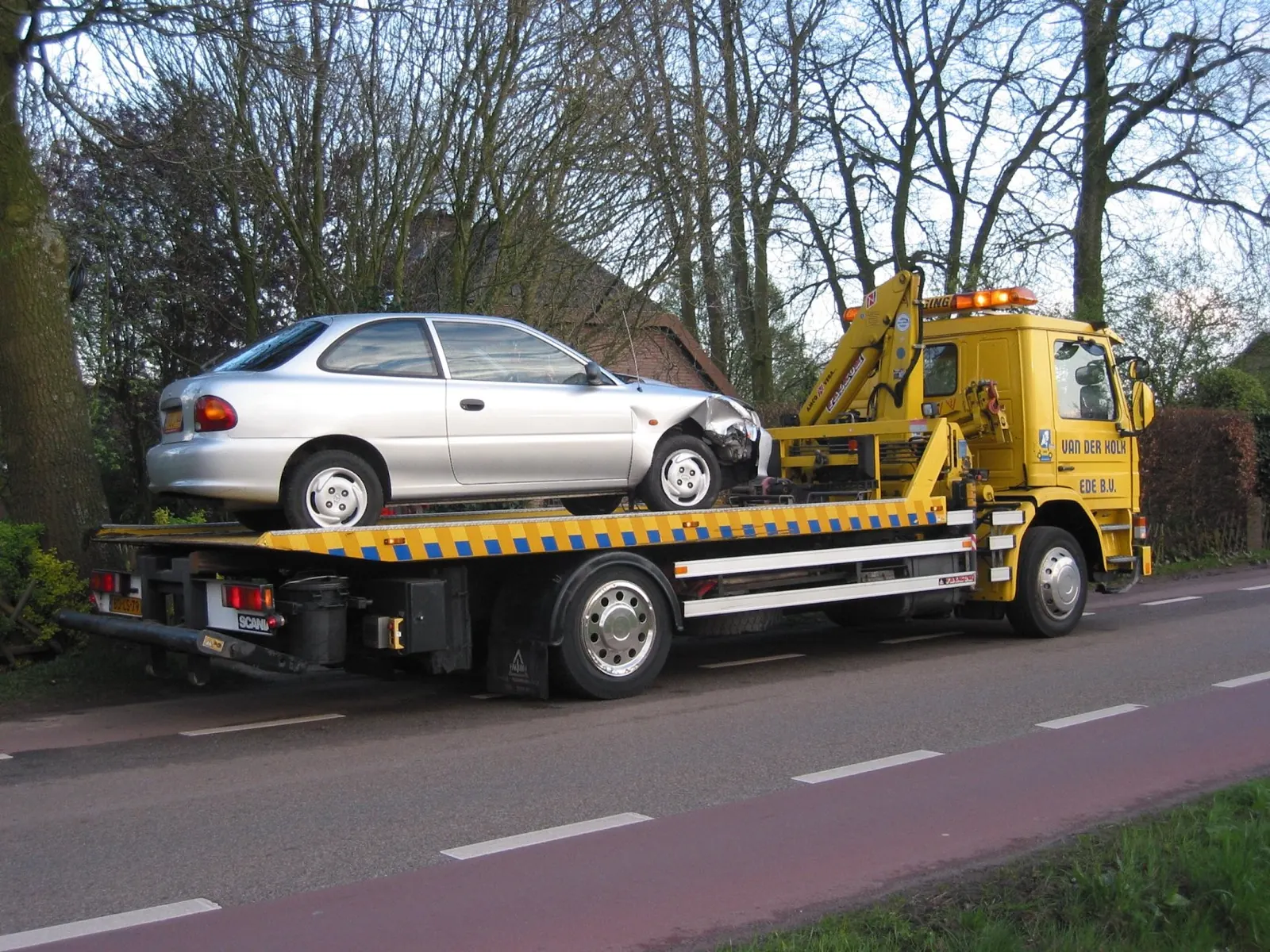 Flatbed tow truck carrying a car