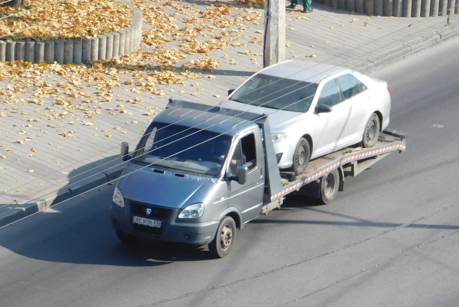 Sedan transported on a flatbed truck