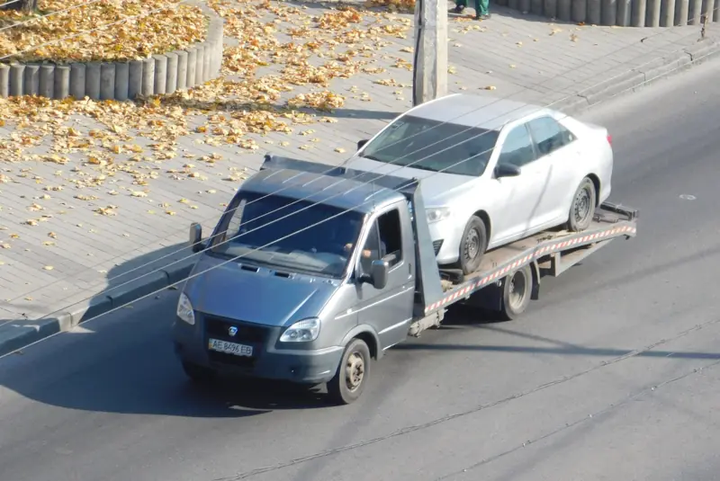 Sedan transported on a flatbed truck