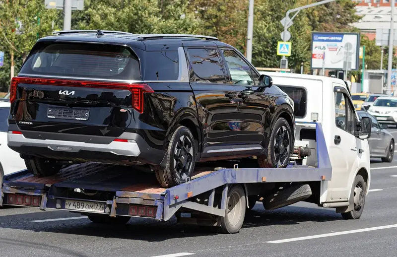 SUV secured on a flatbed truck for transport